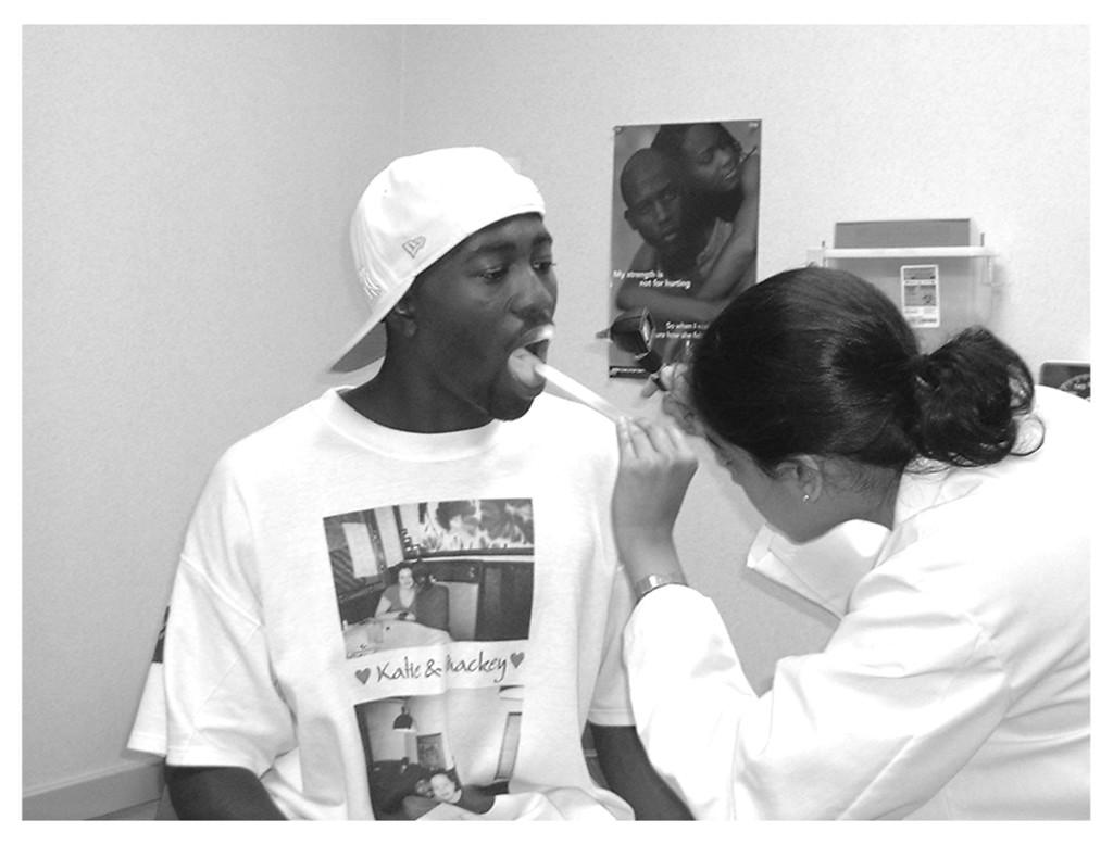 A teenage patient gets his throat examined by a U of M doctor at the Corner Health Center in Ypsilanti, Michigan.