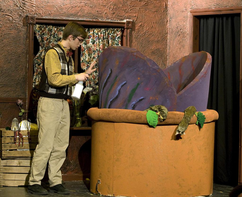 Eli Rhodenhiser, as Seymour, feeds his monster-plant Audrey II