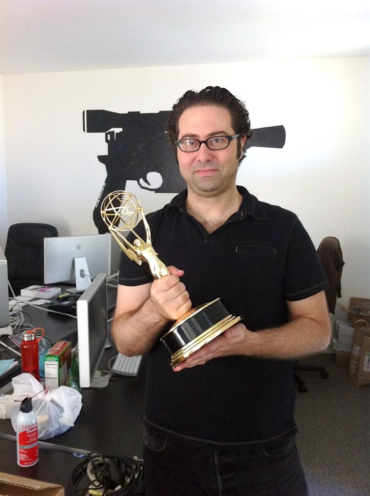 McDermott holds up the Emmy award.