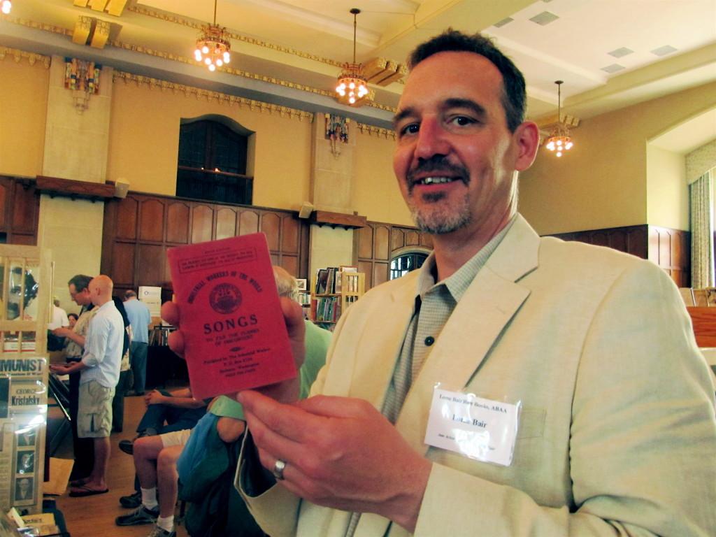 Bair with one of his purchases, a fifth edition IWW Songbook.