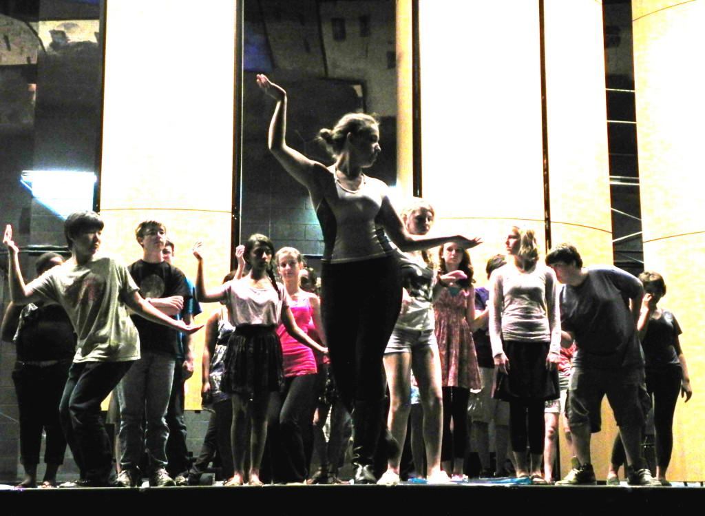 Students rehearse a dance with a University of Michigan student choreographer. 
