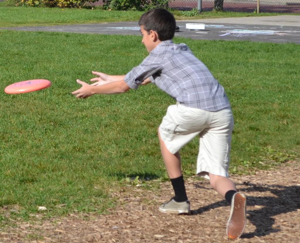 Freshman Isaac Scobey-Thal throws a frisbee on the back law. Scobey-Thal is one of many new recruits to the CHS ultimate frisbee team. 