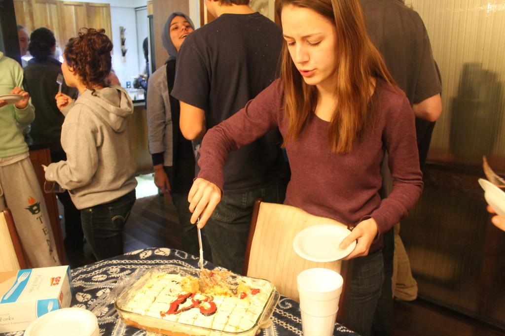 Becca Shipan focuses on cutting a piece of cake. 