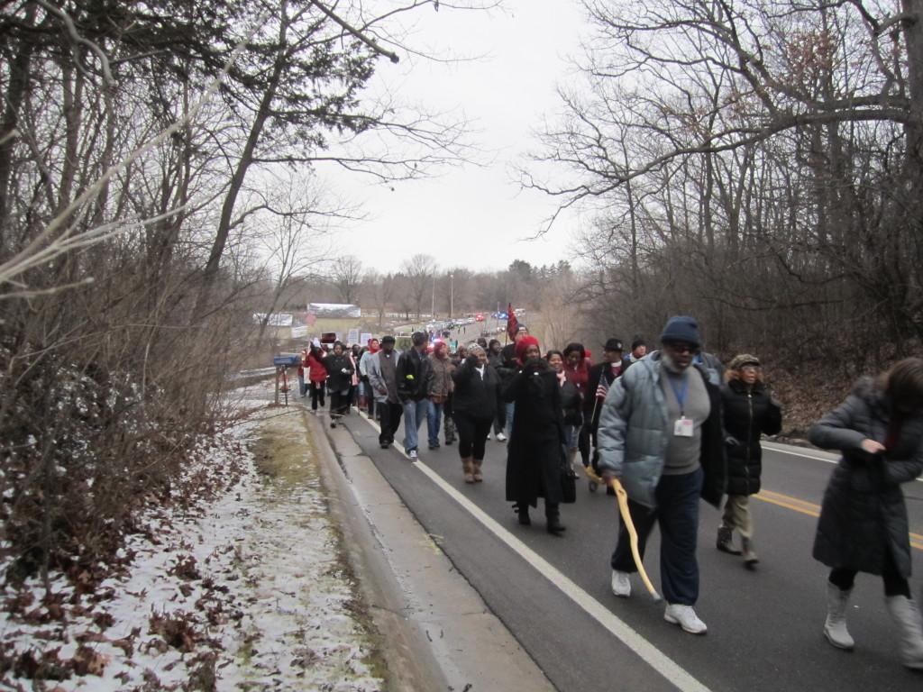 Protesterrs march towards Rick Snyders home
