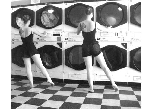 Two ballerinas dance at the Creston Sit-n-Spin Laundry in Grand Rapids, MI. 