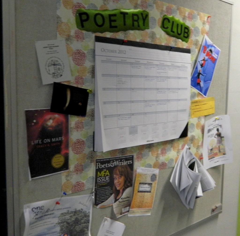 Poetry club bulletin board with important dates and flyers of poets outside of Judith DeWoskins room.