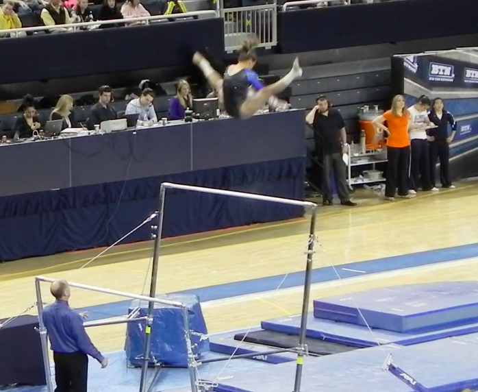 Brittnee Martinez performs a Tkatchev on uneven bars. Martinez tied Joanna Sampson for second place with a score of 9.875. 
