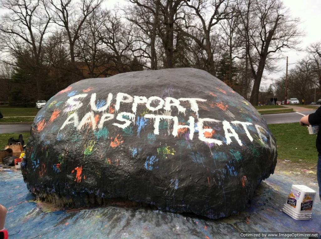 The Rock proudly displays the message SUPPORT AAPS THEATER