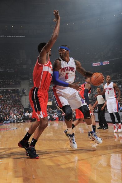 Josh Smith looks to score in his first game as a Piston