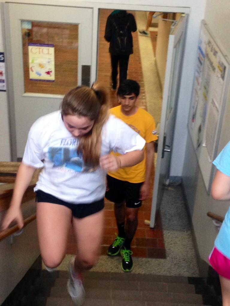 Phoenix Patterson and Mitesh Patel run up the stairs for Personal Fitness. 