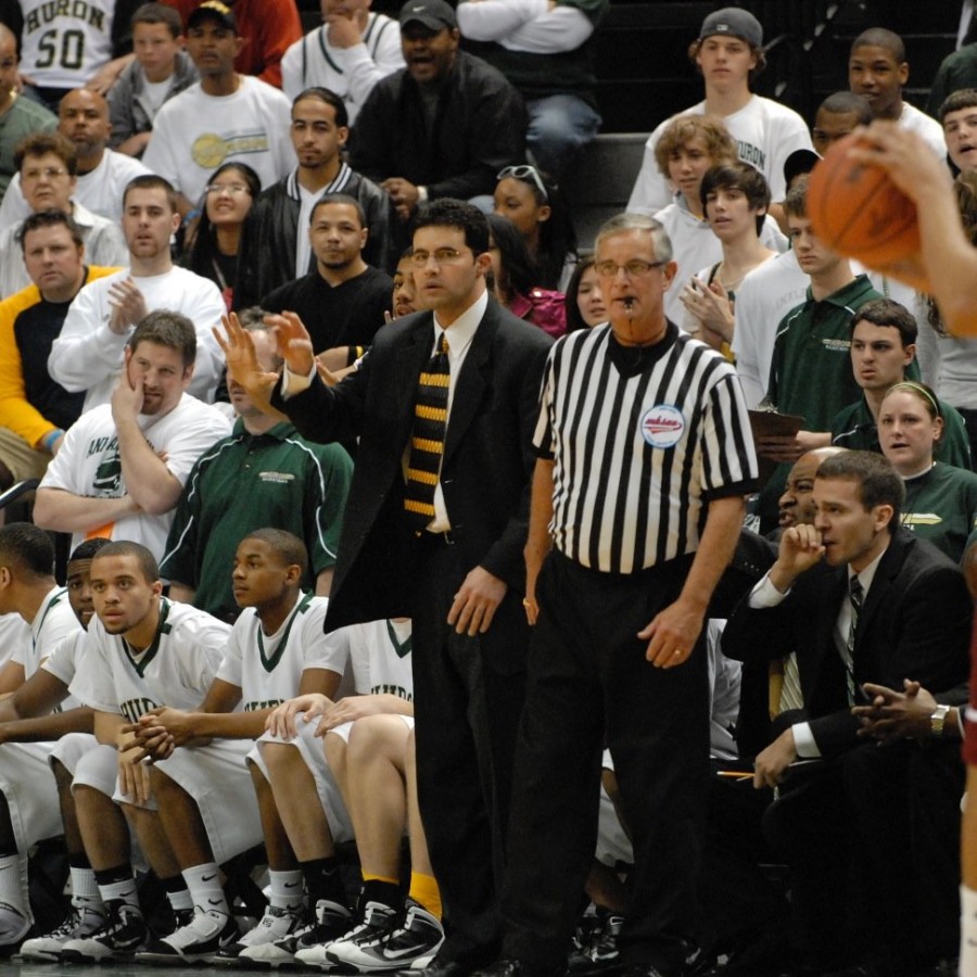 Coach Samah directs his players from the coaching box. In 2010, he led the Huron team to a second place state finish, narrowly losing to Kalamazoo Central 74-65 in the championship match. (Photo courtesy of @HURONBBALL taken from Twitter.)

