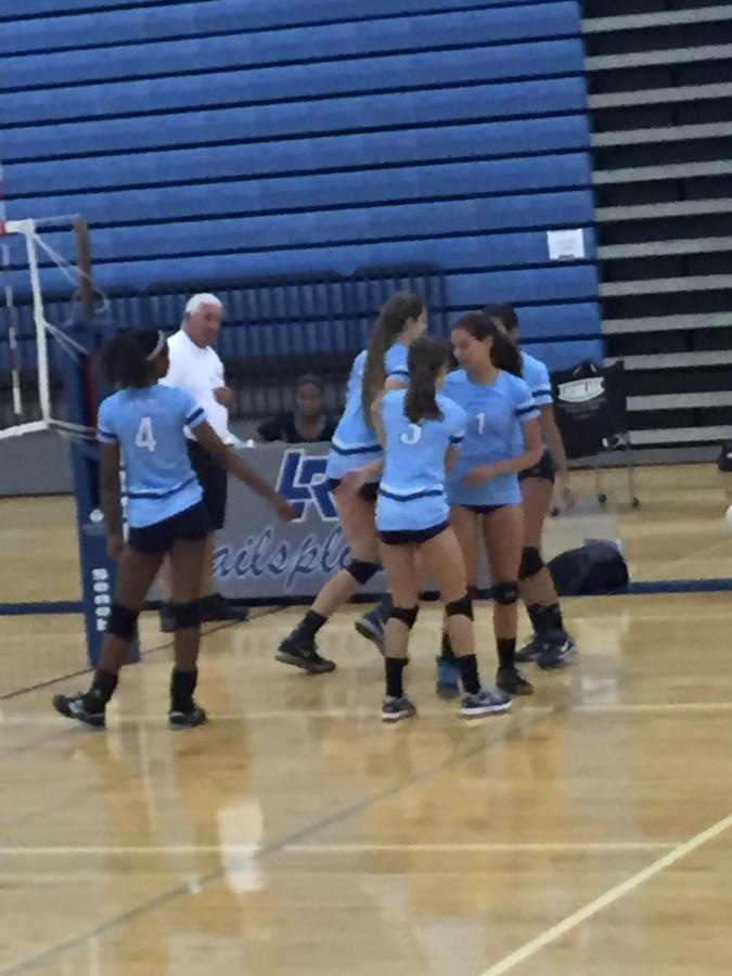 Ella Eliason (3) subs out and Maddie Roberts (1) subs in during the second set. Tylar Benion (4) waits to give Roberts a high five as she comes on the court.