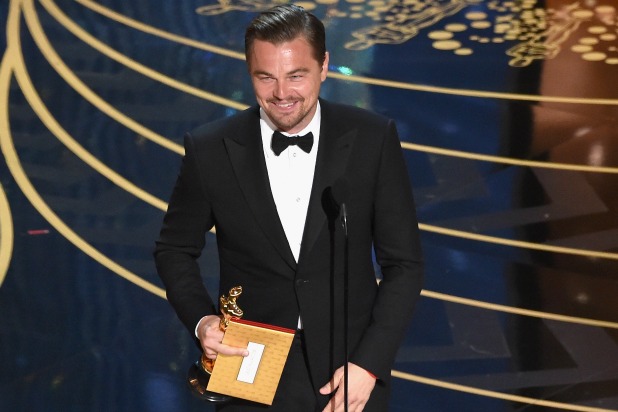 Leonardo DiCaprio finally wins his first Oscar after being nominated four times previously.  He enjoys the moment.