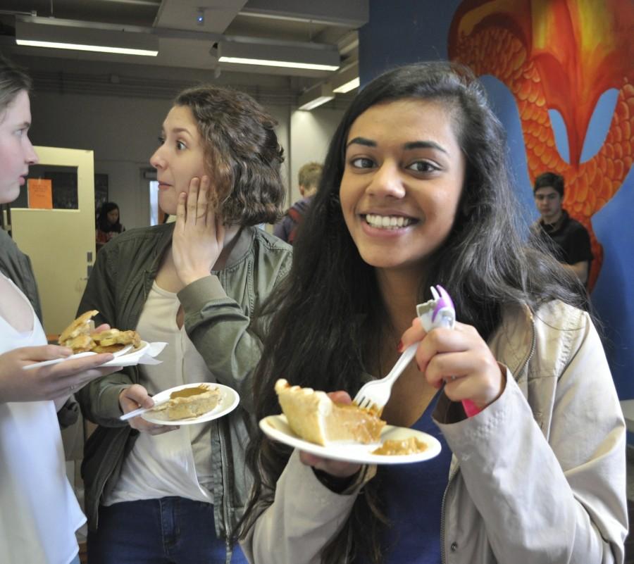 Community High School senior Anurima Kumar grins with her piece of pumpkin pie. Before this, she had a piece of chocolate pie. Kumar is sad that its her last Pi Day at CHS. 