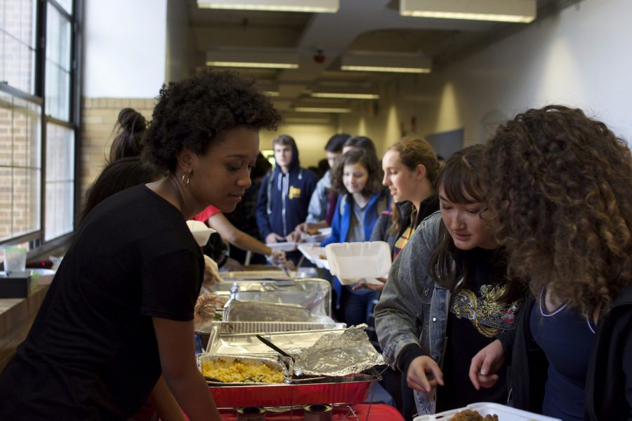 Hevin White, a BSU member, serves hungry students during Soul Food Friday.