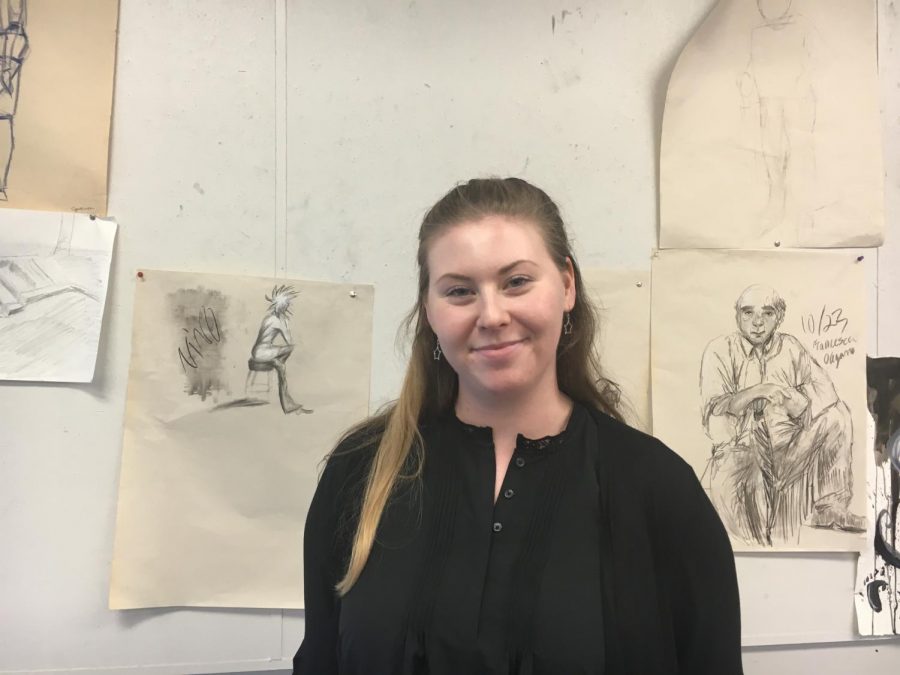Cassidy Moravy-Penchansky stands infront of students art work. She recently became a student teacher at CHS and was an art director at Camp Al-gon-quain.