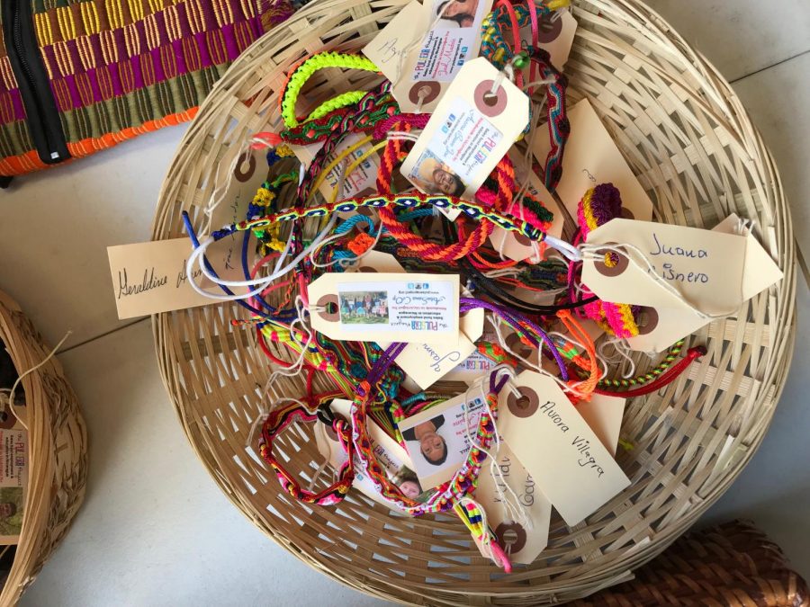 Bracelets sit in a basket on the third floor as high school students proudly sell them. 
