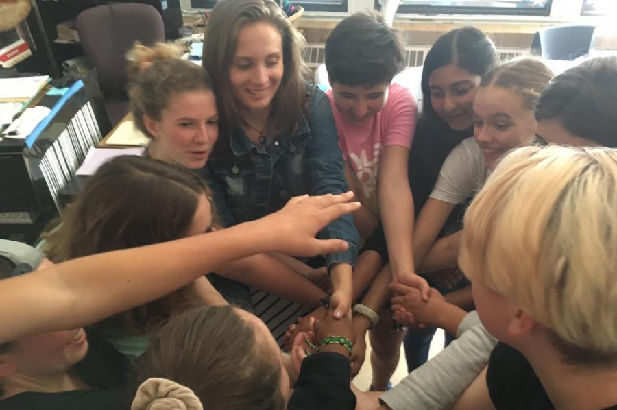 Members of the club participate in "the human knot," a popular team-building activity.