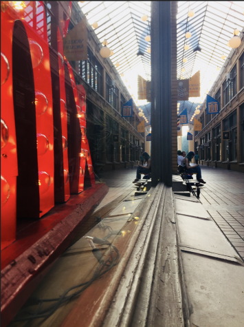 My name is Molly Maloy and I took this picture in Nicholas Arcade because I was trying to take a picture of just the sign and I noticed a cool reflection off the window.