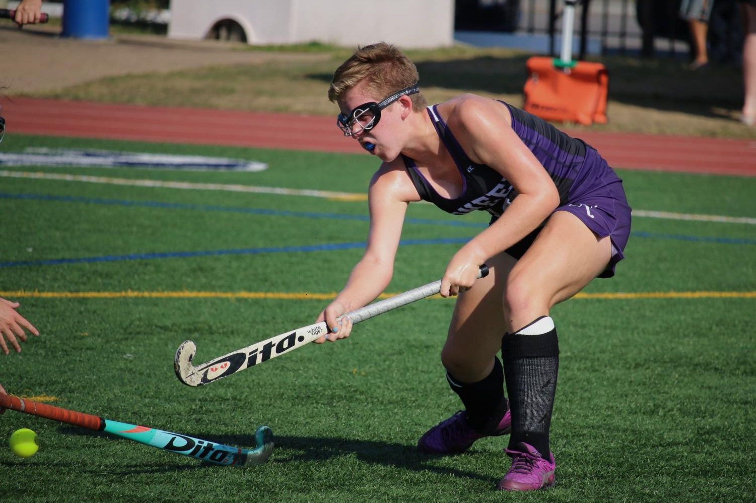 Varsity Pioneer Field Hockey player Lucy Scott pictured with her eye on the ball mid-game. Taken by Andy Brush.