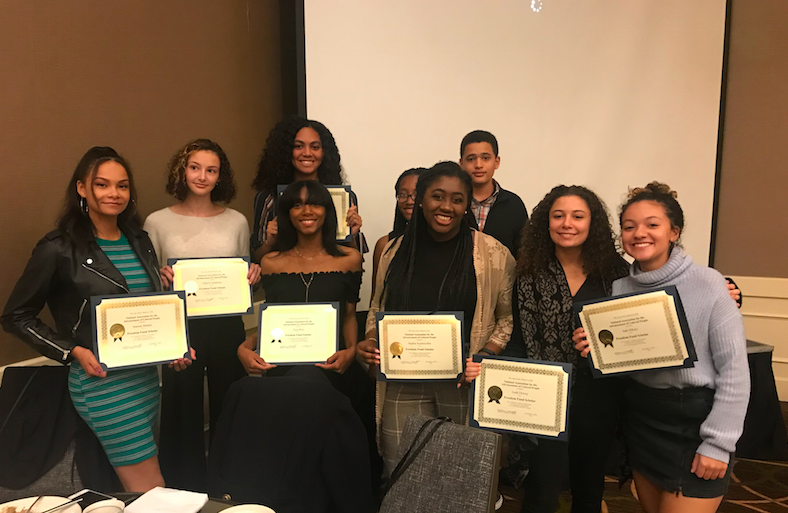 Community High School students at the Freedom Fund Scholars Dinner. Theyre all holding certificates made out to them from the event.