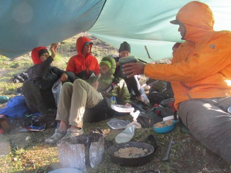 My course group enjoying oatmeal under a kitchen tarp in the Talkeetna Mountain Range in Alaska.