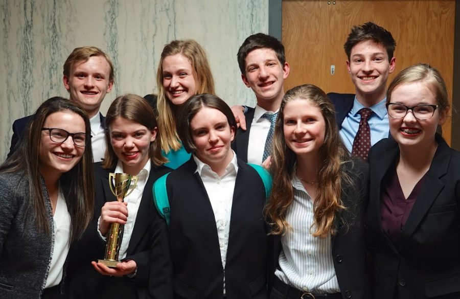 The Community High School A-team following their Washtenaw Regional Tournament on Feb. 23, 2019. The team is holding their trophy in celebration, just seconds after the announcement of their advancement to the State Tournament. The team was one of only two teams that advanced to stated from the Washtenaw County Courthouse
