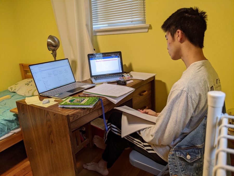 A self-portrait of my bedroom workspace. Since getting a new laptop, Ive kept my old one around so I can search on another screen, or to take over if my newer laptop has any issues connecting to the home wi-fi, which is awful as of late. I find it cramped and uncomfortable, but it is often my only portal to the outside world.