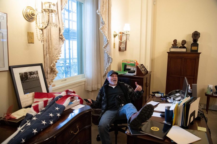 A supporter of President Donald Trump sits inside the office of U.S. Speaker of the House Nancy Pelosi as he protests inside the U.S. Capitol in Washington, D.C., on Jan. 6, 2021. Demonstrators breached security and entered the Capitol as Congress debated the a 2020 presidential election Electoral Vote Certification. (Saul Loeb/AFP/Getty Images/TNS) 