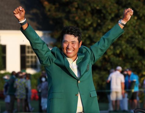 Hideki Matsuyama is presented the green jacket as he celebrates winning the Masters on Sunday, April 11, 2021, at August National Golf Club in Augusta, Georgia. (Curtis Compton/Atlanta Journal-Constitution/TNS)