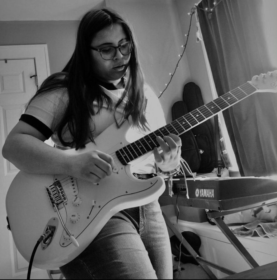 Sofia+plays+her+solo+with+her+white+Silvertone+guitar.+She+spends+countless+hours+playing%2C+trying+to+find+the+feeling+of+each+track.+%E2%80%9CIt%E2%80%99s+nice+to+be+able+to+accompany+myself+while+singing%3B+it+takes+me+somewhere+where+I+know+I+can%E2%80%99t+mess+up%2C%E2%80%9D+Stern+said.