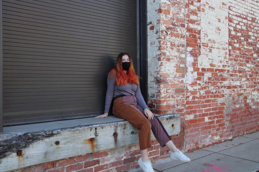 Audrey Weiss leans up against a wall in Kerrytown. She generally goes to Kerrytown for kombucha or a coffee. My favorite part of Kerrytown is the courtyard, I have a lot of memories with friends there, and its also just a really beautiful place, Weiss said. 