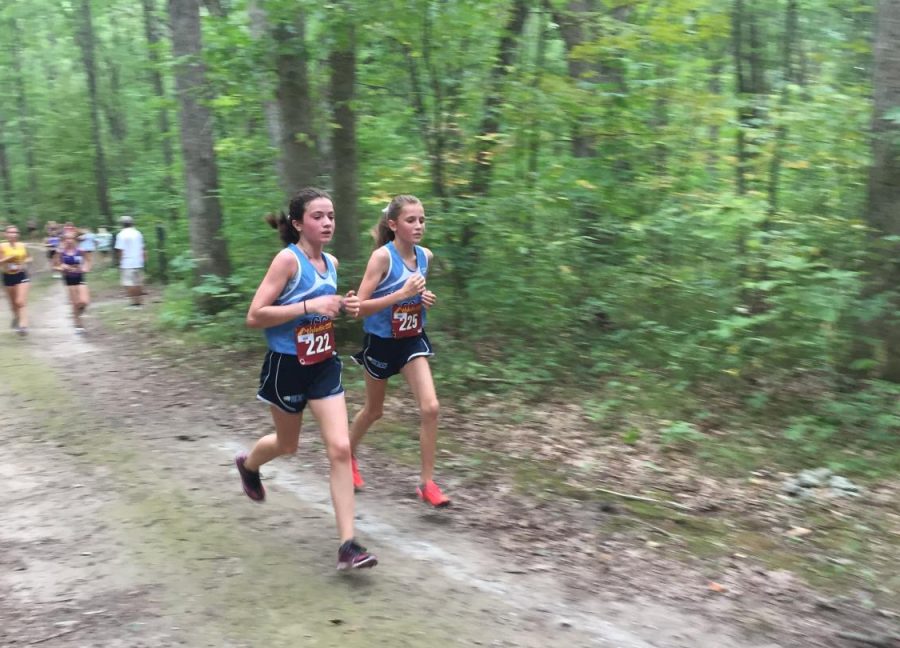 Natalie Kessler (right) running with Lydia Cocciolone (left) in the Portage Invitational. She finished in 35th place, running her fastest 5k. I PR-ed by two minutes, Kessler said, PR is a personal record.