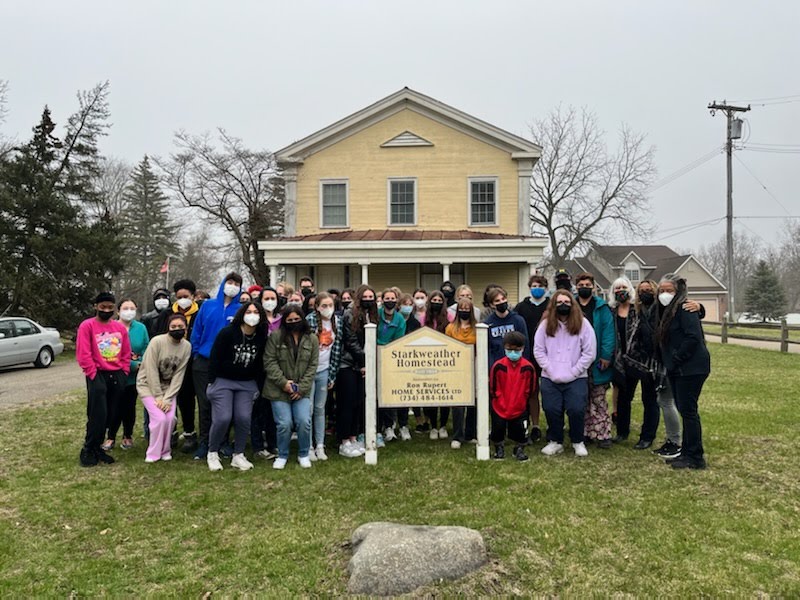 Students gather in front of the Starkweather Homestead in Ypsilanti which was known as a safe house on the Underground railroad.
