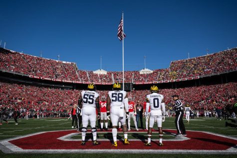 Mazi Smith (58) stands at midfield for the coin toss before Michigans game against Ohio State