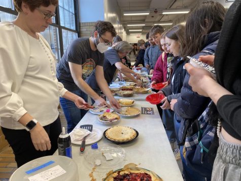 Students line up along tables on the third floor to receive their pie, served by teachers and administrators.