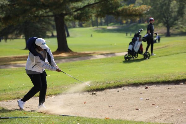 Ali OBrien hits out of a bunker at the 2022 MHSAA State Tournament. This is Obriens fourth year on the golf team. “Its been such an amazing journey,” O’Brien said. “With this being my last season, Im a little sad because of course I want to come back next year and play. But Im also so happy to see the progress I’ve made from being a scared freshman who didn’t know how to golf to being a senior who has so much fun playing golf.