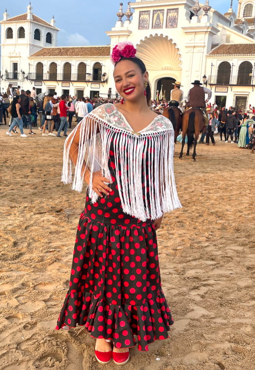 Klava Alicea at the Rocío festival in front of the church of Santa María while the pasos present themselves to the church. 