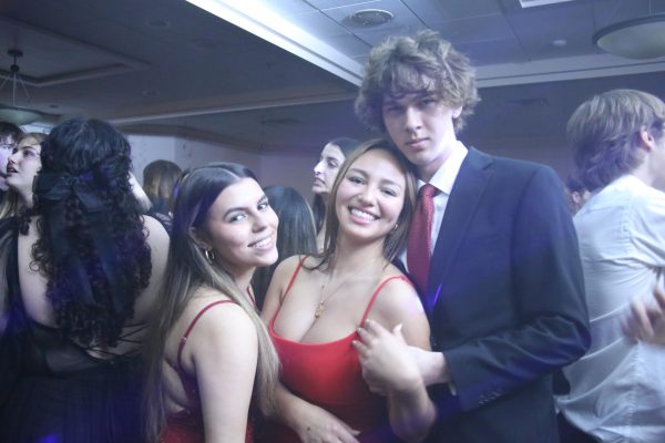 (Left to right) Natalie Serban, Klava Alicea and Connor Jett look away from the dance floor for a photo.