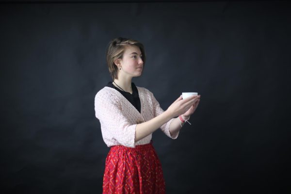 Kaylie Peters holds up a cup from a traditional tea set. Peters was taught that in a tea ceremony it is customary to present things with two hands. My Baba has taught me a lot about Japanese culture, Peters said. Its all credited to her.