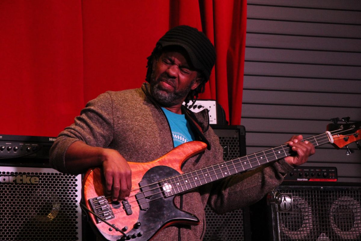Victor Wooten plays bass on center stage during a master class. He was showing the campers how to communicate with the drummer and keep a jam interesting.
