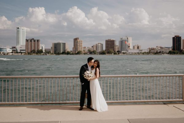 Photography by Destany Colagrossi
Luciana and Kai Qu pose for photos by the waterfront in Detroit. They took photos to document their special moment. “I would say we just kind of get each other,” Qu said. “We just get each other’s  vibes. We don’t have to talk very much. I think it’s one of those relationships where you are just super good friends. We are best friends, but we also really love each other.” 