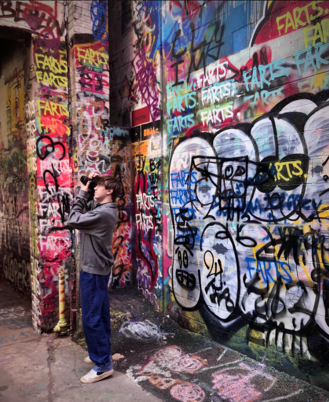 March - Jack Lewis takes photos at graffiti alley for his photography CR. Lewis has gone on multiple photography walks in the past, looking to find good shots of Ann Arbor. Ive never taken photos in graffiti alley before but it was a really great place to shoot, Lewis said.