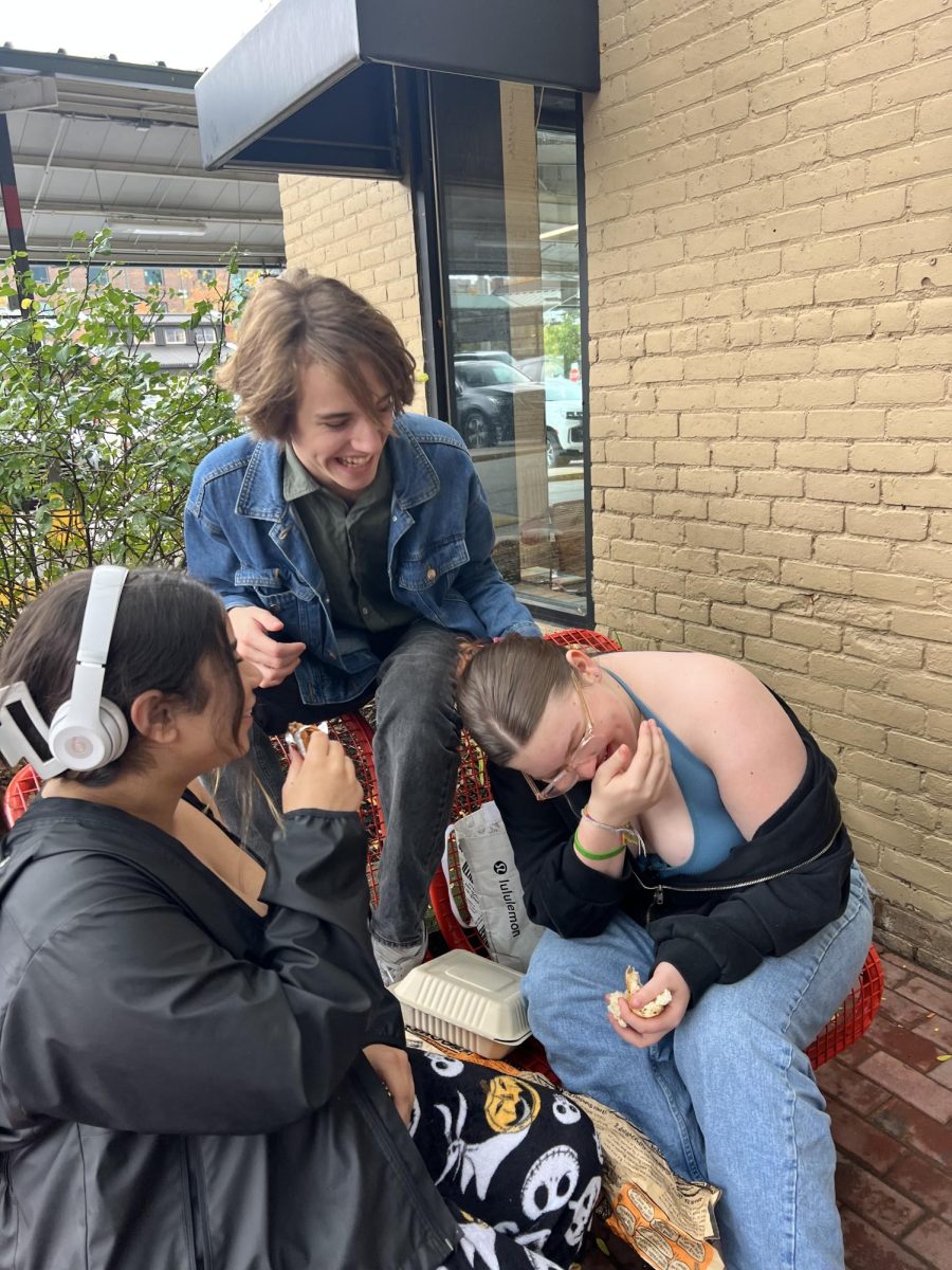 October - Three CHS students (Left to right: Aja Bullard, Luca Hinesman, Piper Cooke) eat lunch outside of Malofta Vintage at Kerrytown. Theyve been doing so since the beginning of the year. Quote needed.