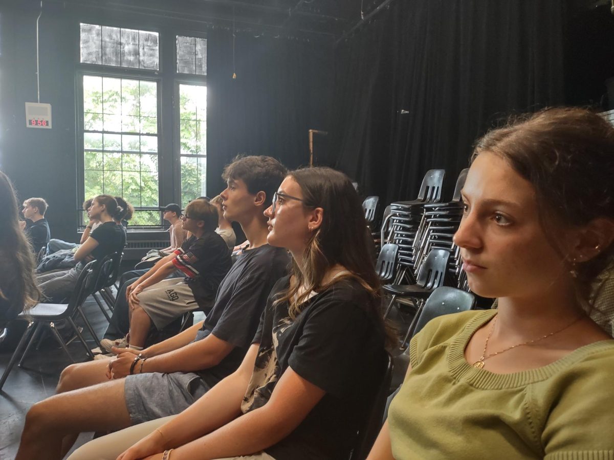 Augustus Kaschube, Tia Cocciolone and Nina Beals (left to right) watch Smith's presentation.