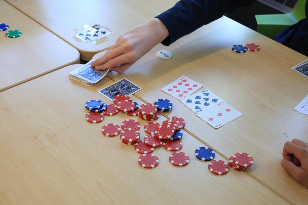 A card is being drawn in the Poker game Texas Hold'Em.