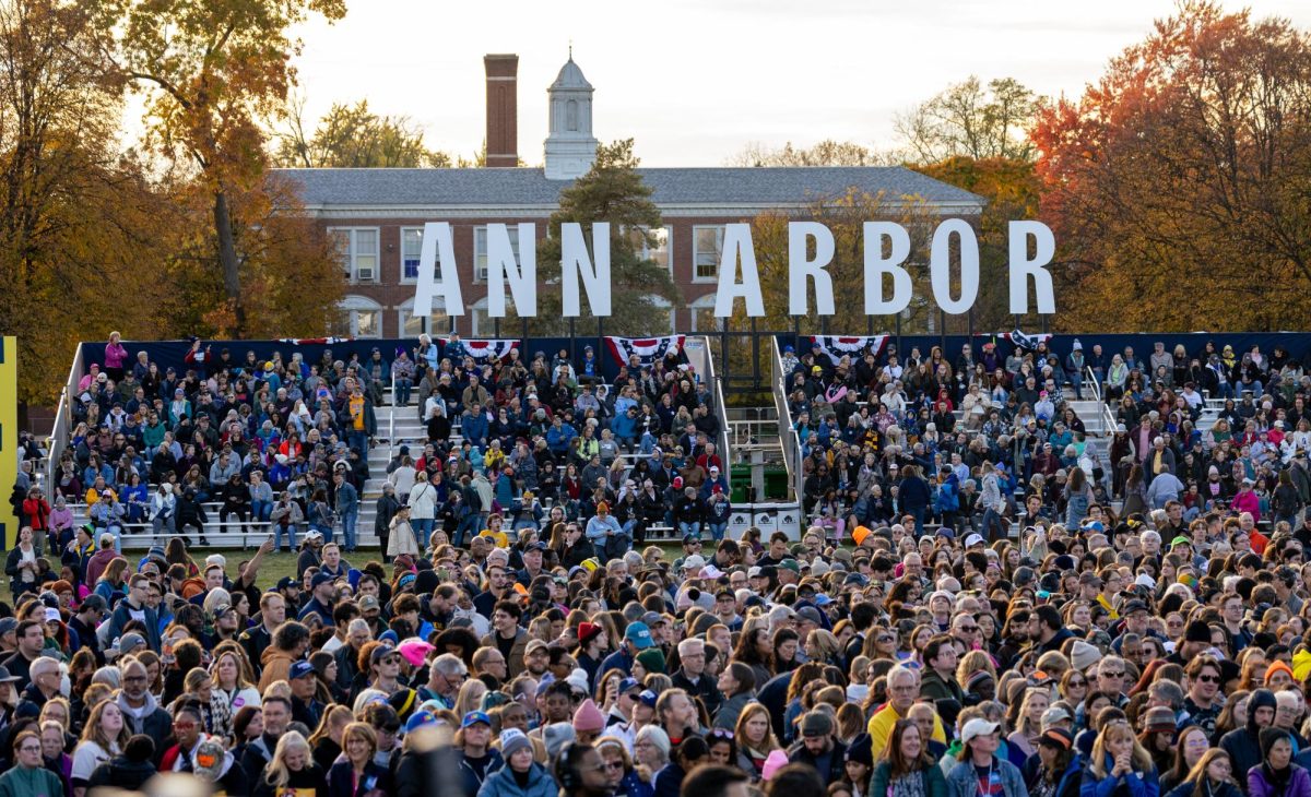 Crowd members at the rally wait to see Kamala Harris and Tim Walz.