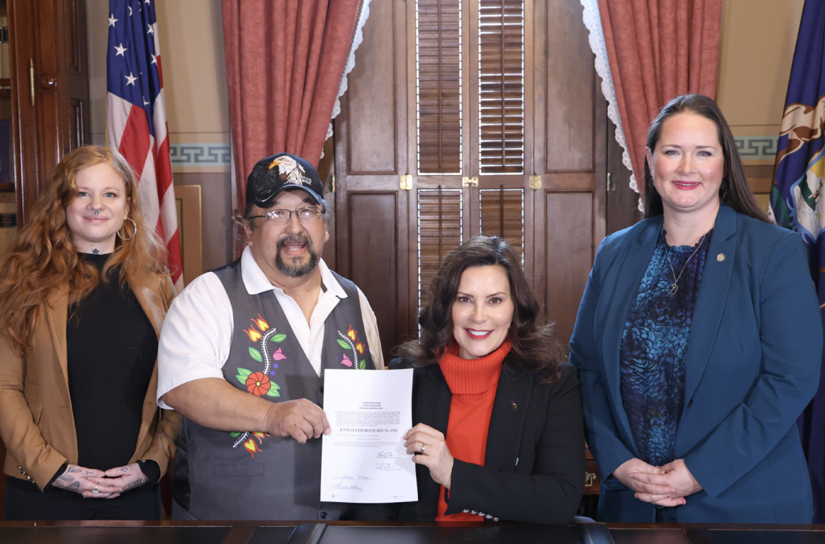 Photo courtesy of Carrie Rheingans.

Carrie Rheingans stands next to Governor Gretchen Whitmer and Indigenous community representatives for the signing of house bill no. 4852. That signing made manoomin the official state native grain. “The word Michigan even comes from Anishinaabemowin, which is the language of the Great Lakes peoples, the Ojibwe, the Odawa and the Potawatomi. I think it’s really important for us to really keep honoring their contributions and keep moving forward,” Rheingans said.