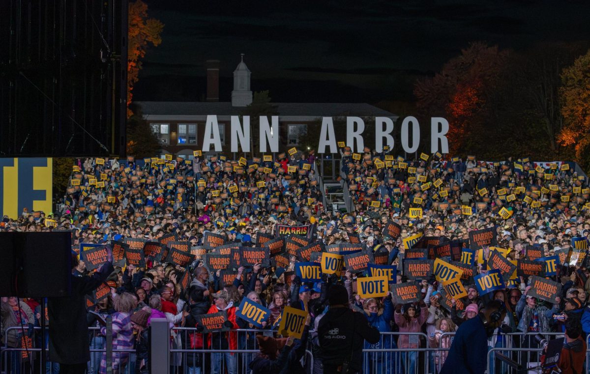 An eager crowd waives their signs at the "When We Vote" rally. With just eight days until election Day, the Harris/Walz campaign came to Ann Arbor, Michigan, with guest artist Maggie Rogers. 