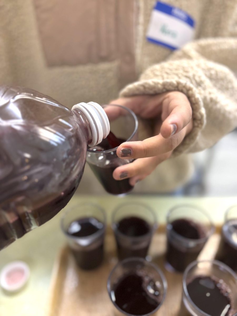 Kirra Molek serving grape juice at St. Andrews Breakfast Program